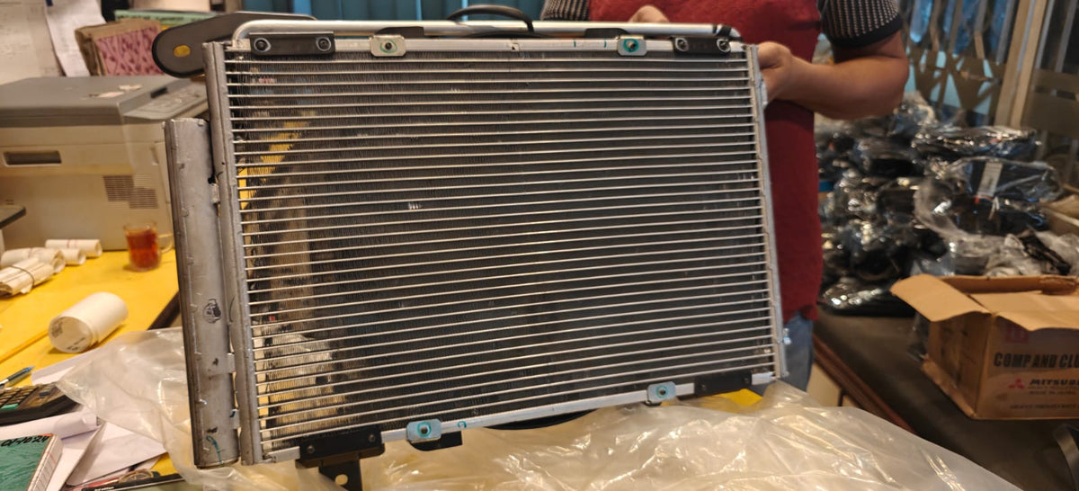 Radiator on a workbench with tools and parts in the background