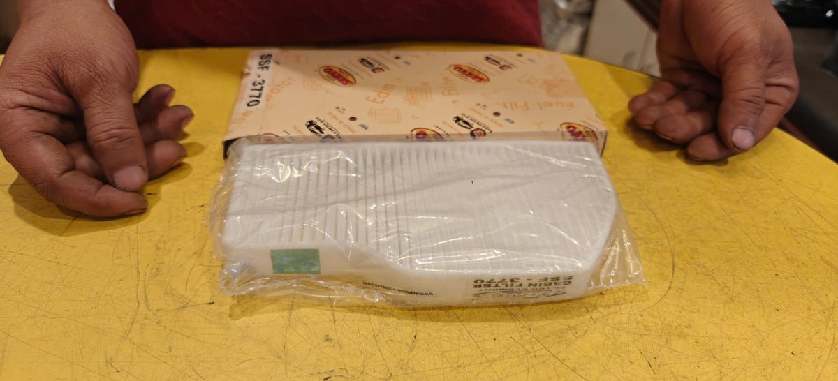 Packaged product on a yellow surface with hands on either side