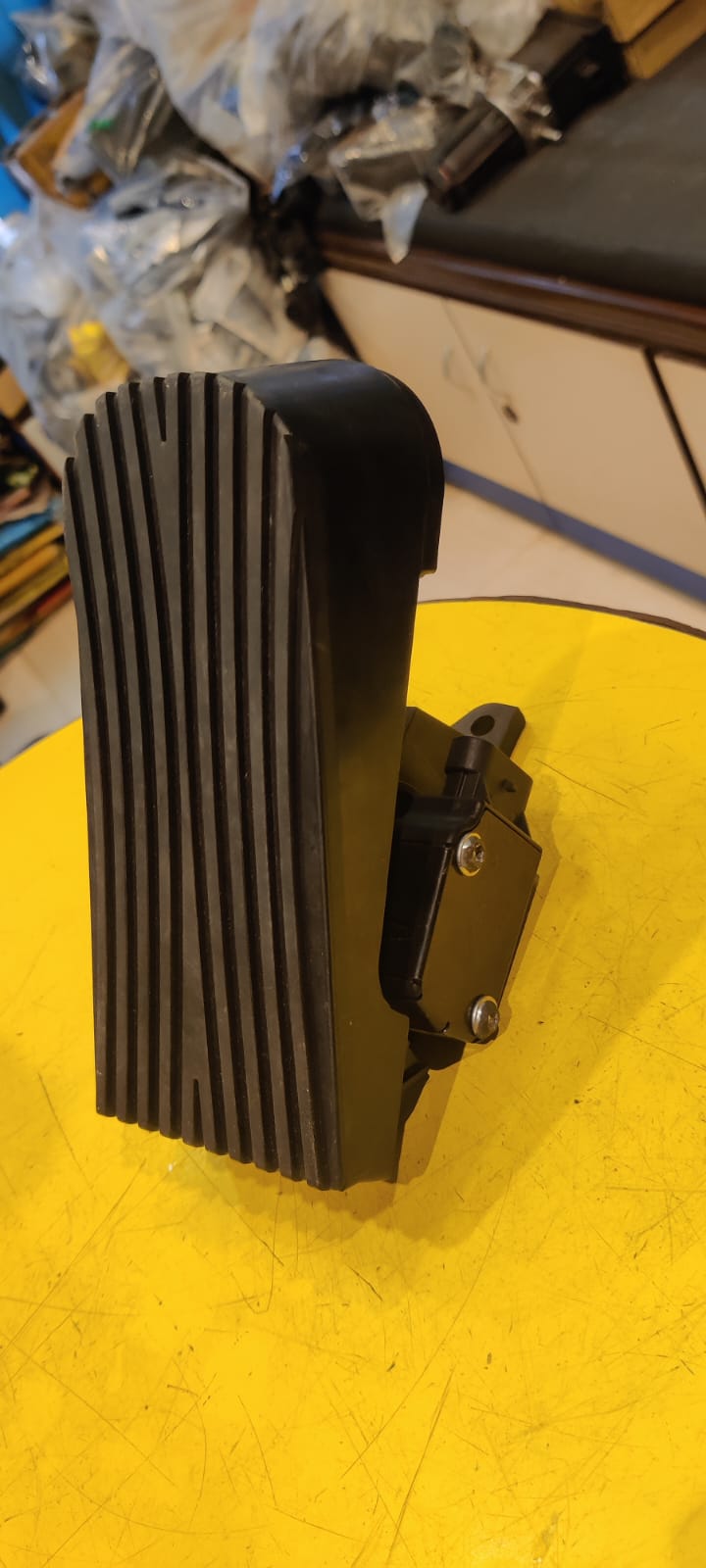 Black electronic device on a yellow surface with a blurred background