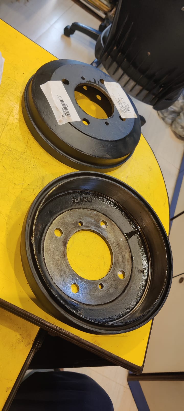 Two mechanical components on a yellow surface