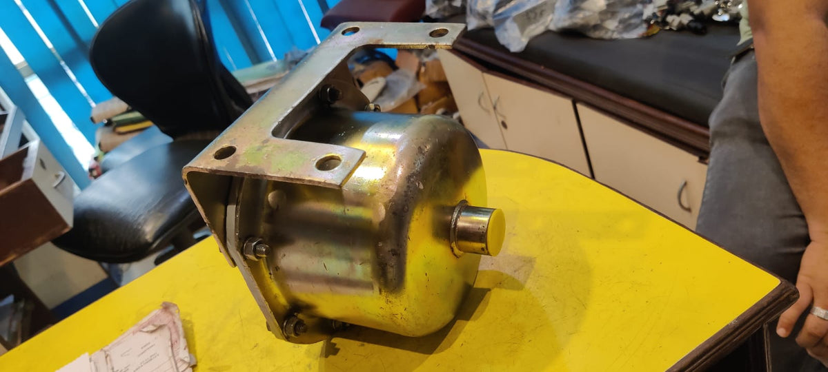 Mechanical component on a yellow surface with a person partially visible