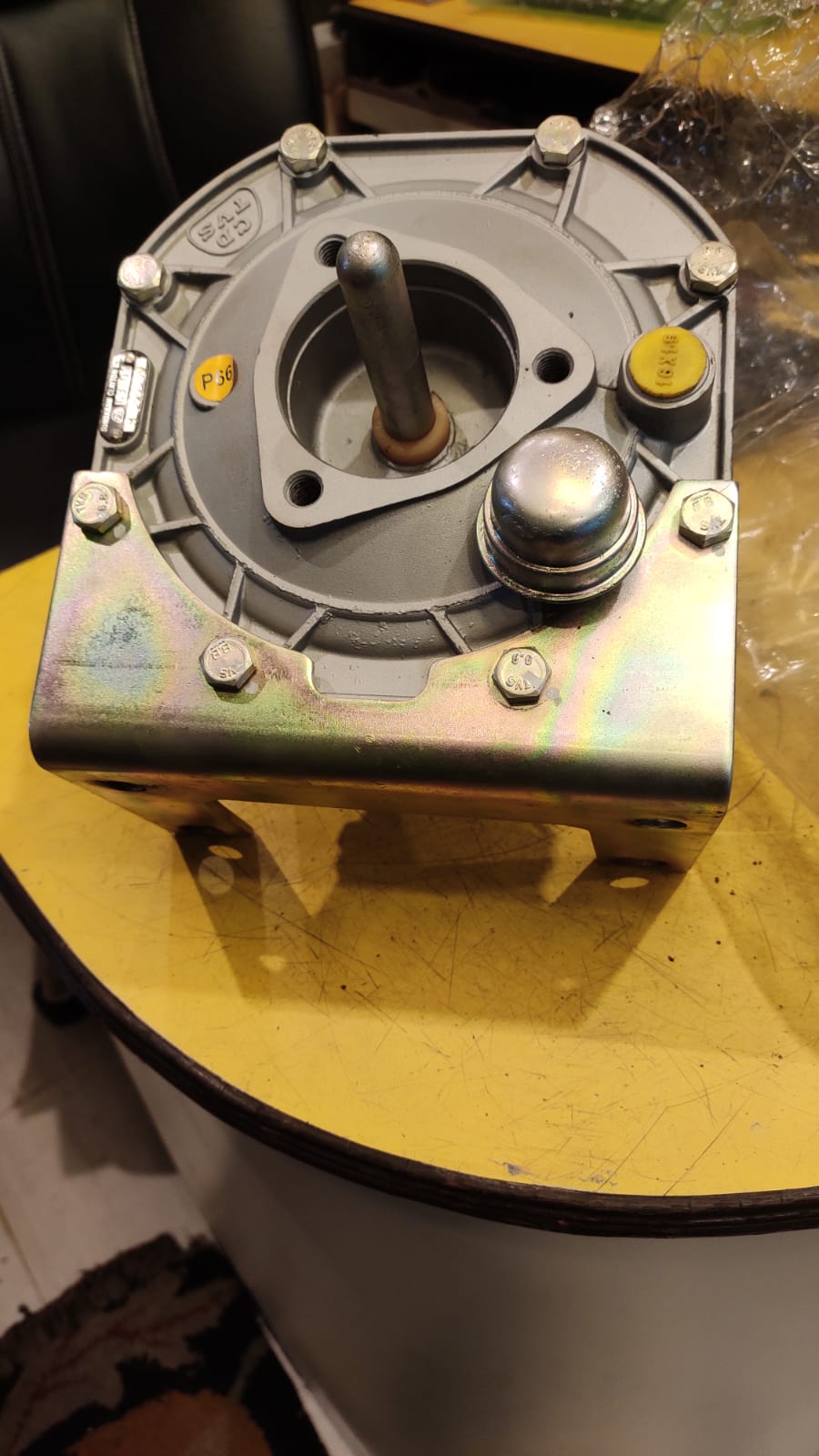 Mechanical component on a yellow surface