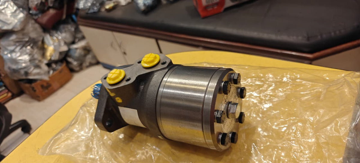 Mechanical component on a yellow surface with a blurred background