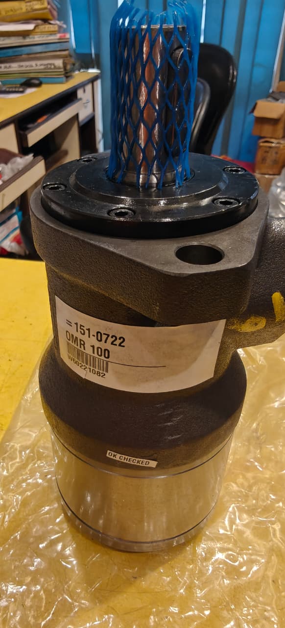 Mechanical component with blue spool on a yellow surface