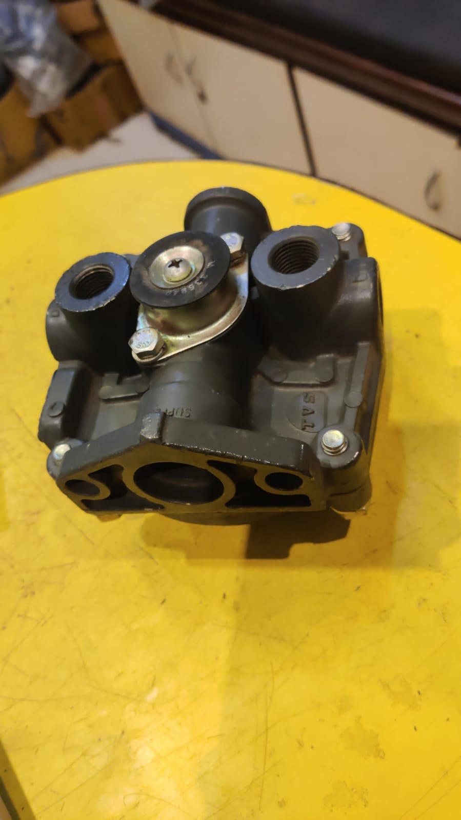 Mechanical component on a yellow surface