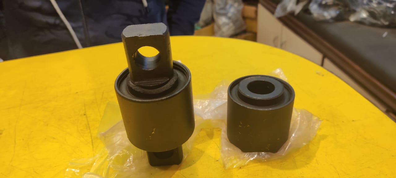 Two mechanical components on a yellow surface with a blurred background
