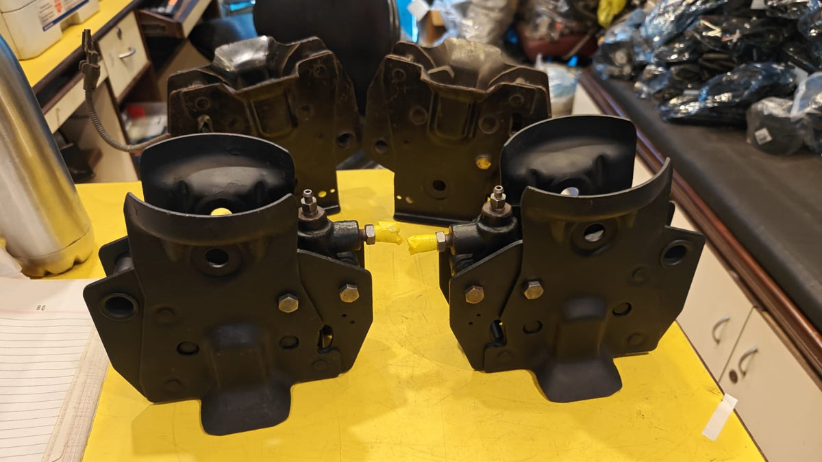 Black mechanical components on a yellow surface with a blurred background
