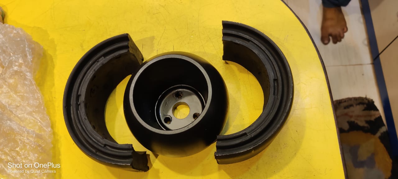 Mechanical component on a yellow surface with a blurred background