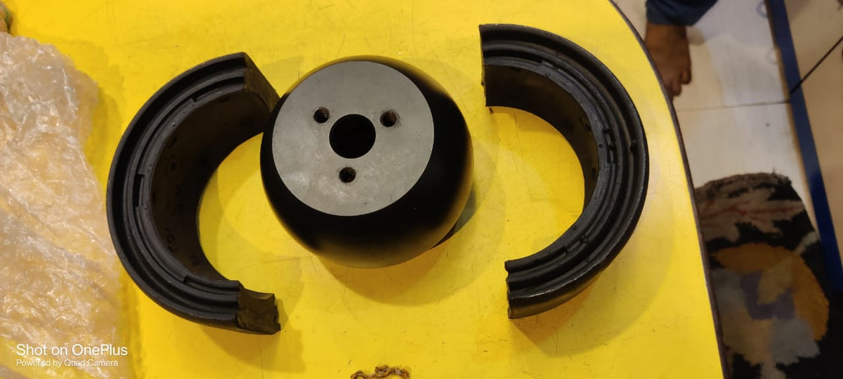 Mechanical component on a yellow surface with a blurred background