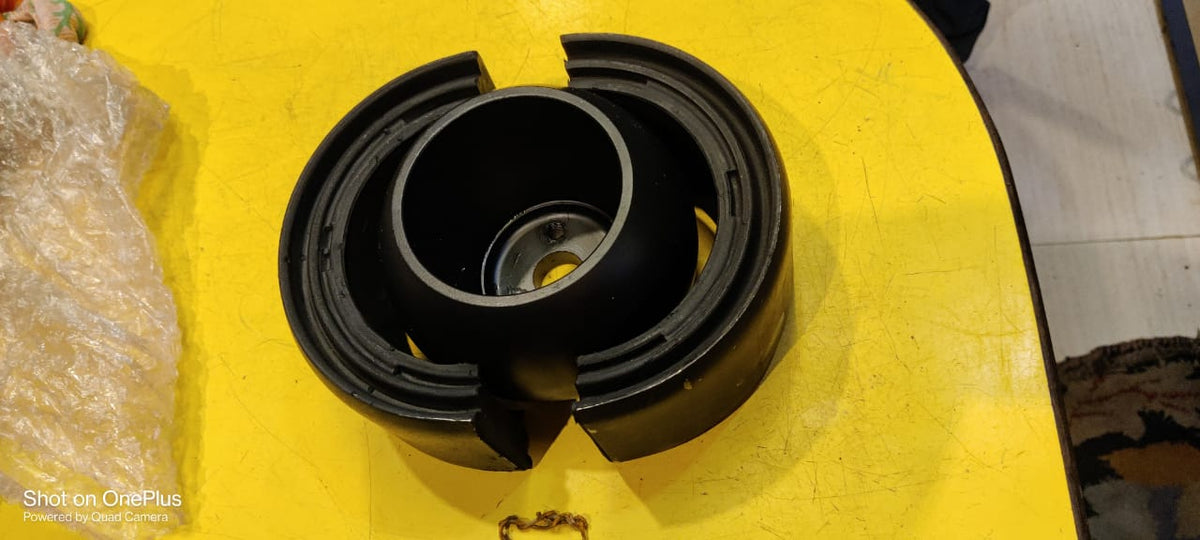 Black mechanical component on a yellow surface