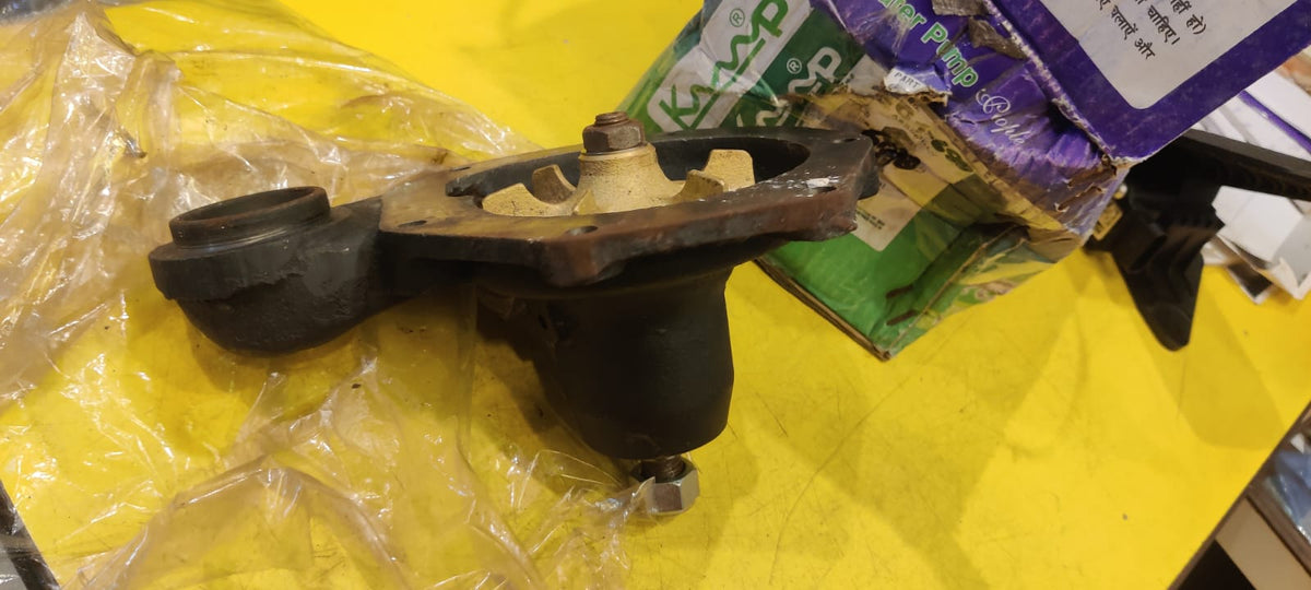 Mechanical part on a yellow surface with packaging in the background