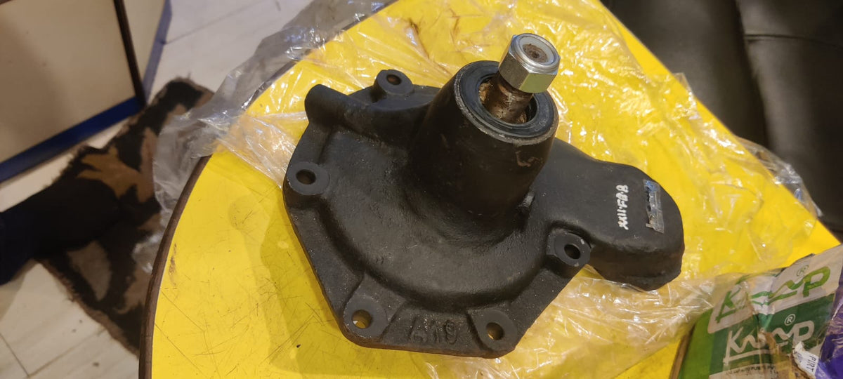 Mechanical part on a yellow surface with a plastic bag in the background