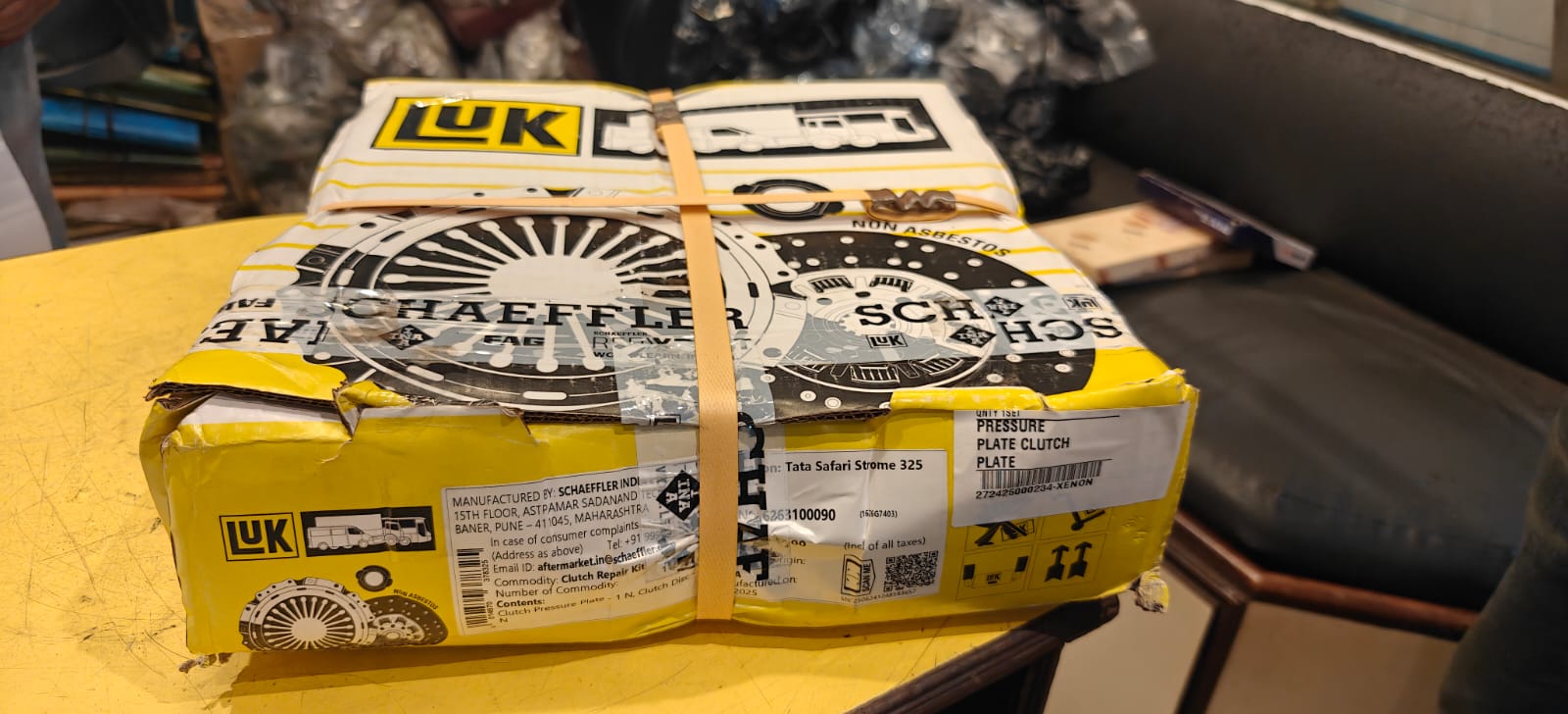 Stack of automotive parts boxes with visible brand names on a table.