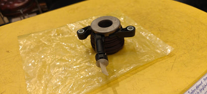 Mechanical part on a yellow surface with clear plastic wrap