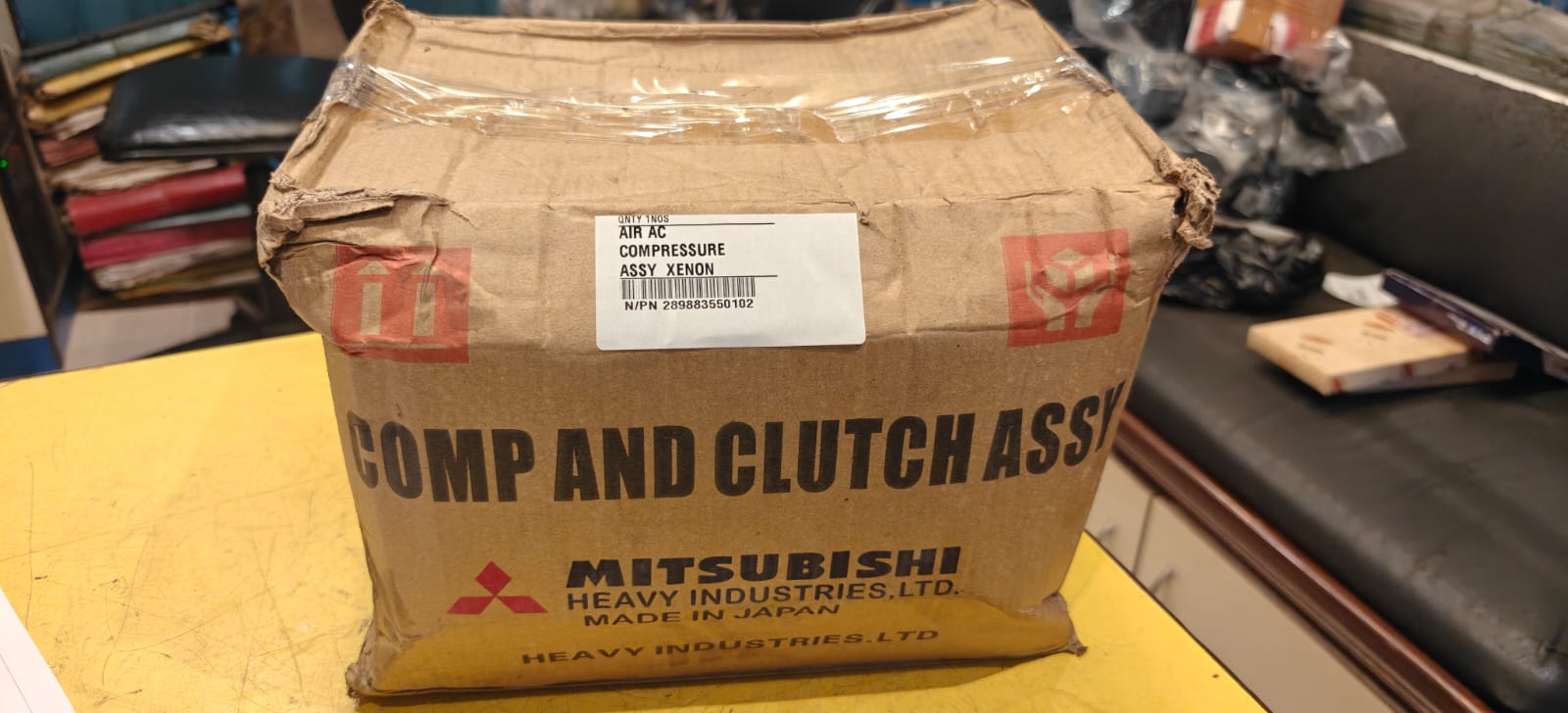 Cardboard box with Mitsubishi Heavy Industries label on a desk