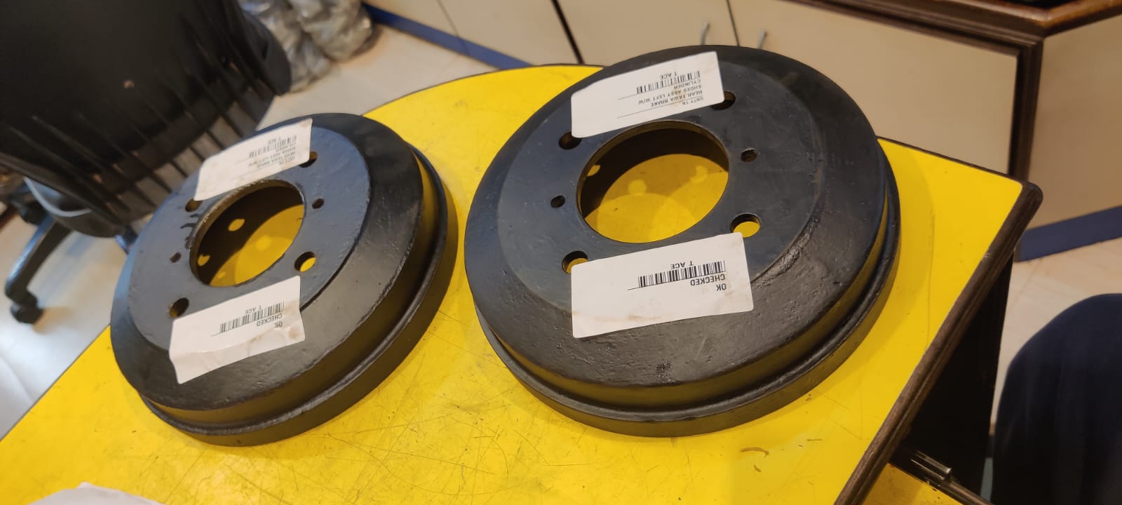 Two black circular components with labels on a yellow surface