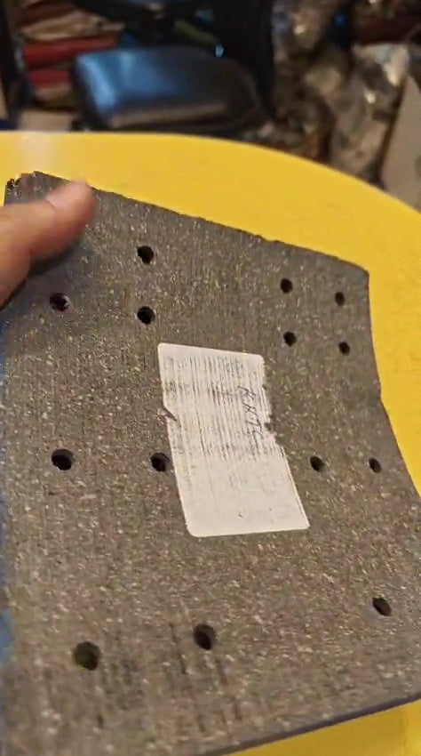 Textured black object with a label on a yellow surface