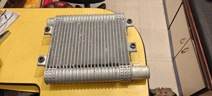 Metallic radiator on a yellow surface with a blurred background mahindra scorpio intercooler