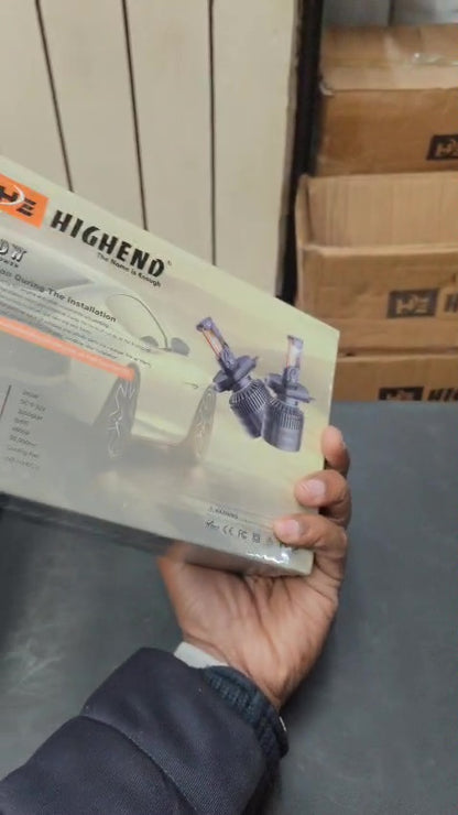 Hand holding a product packaging with 'HIGHERNO' branding in an indoor setting.