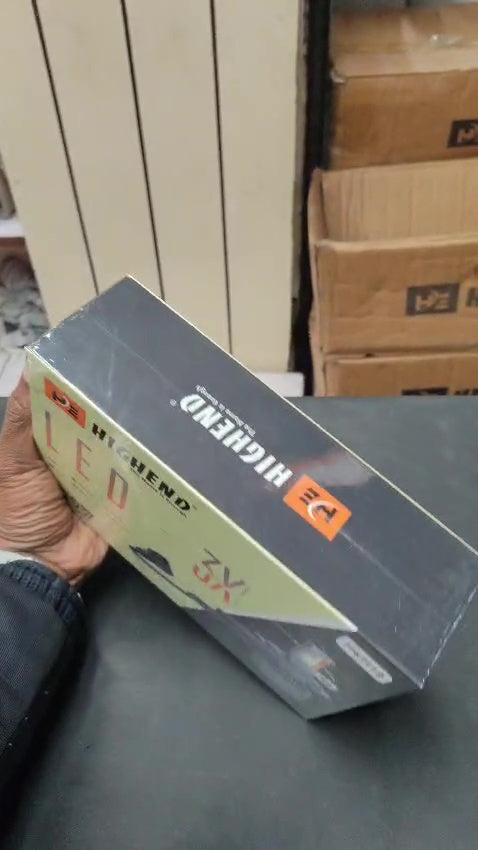 Box of RIGLENG LED TV screen repair parts on a table with cardboard boxes in the background.