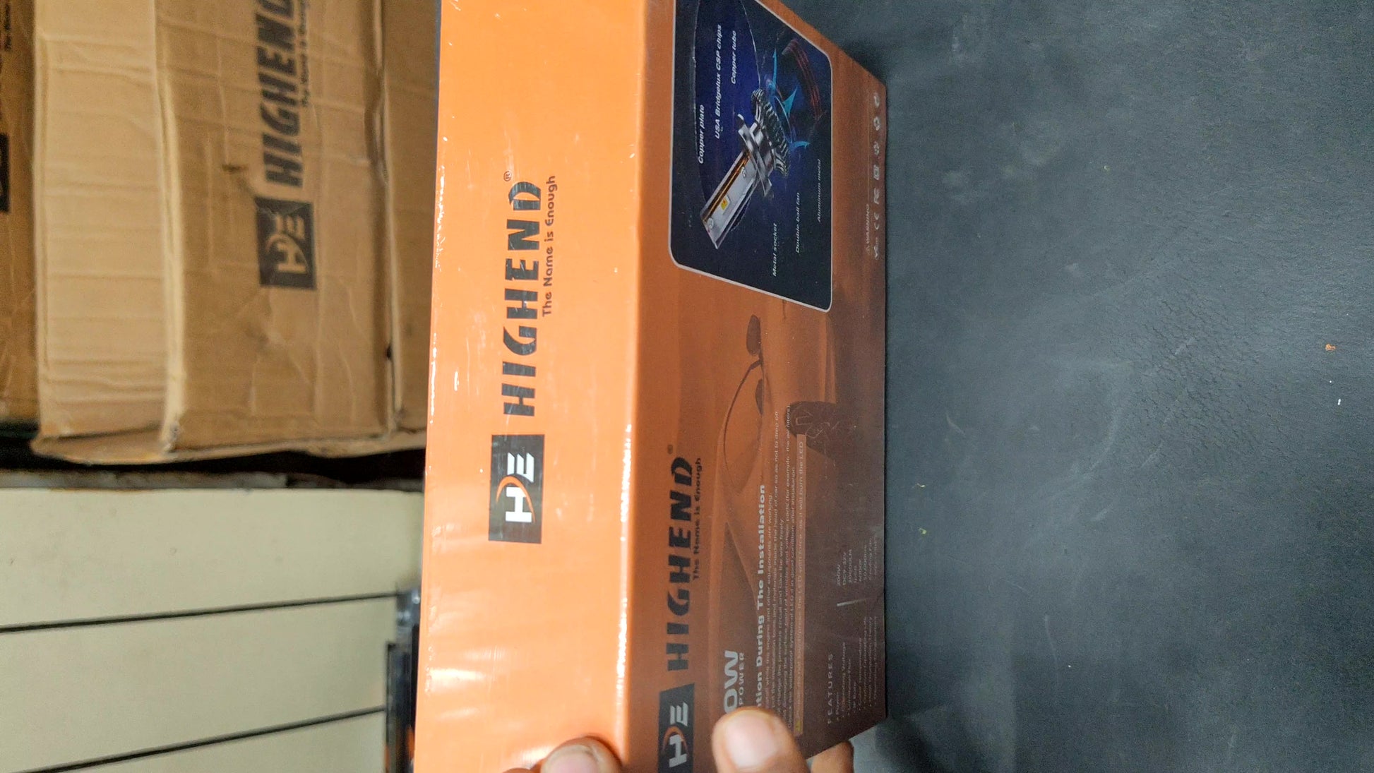 Orange and brown box with 'HighEnd' branding on a dark surface