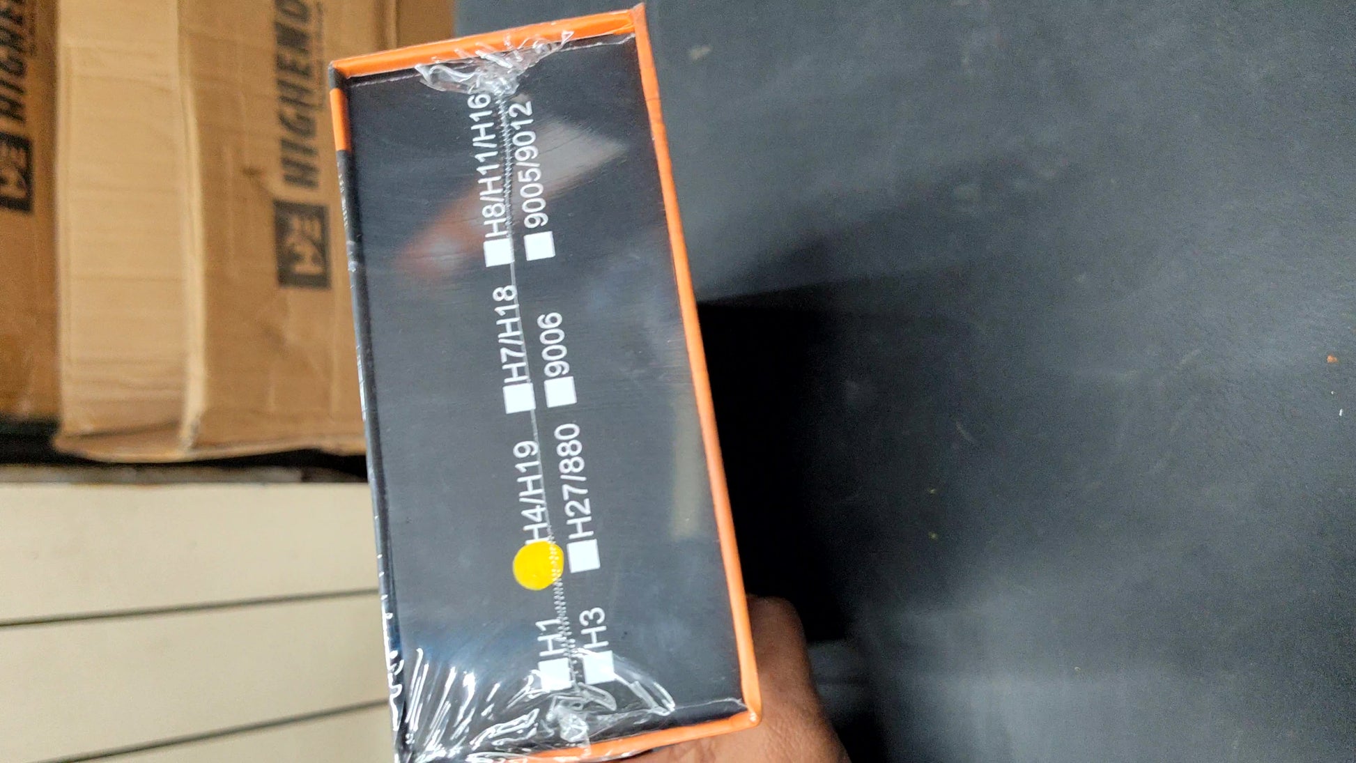 Black box with orange border on a dark surface