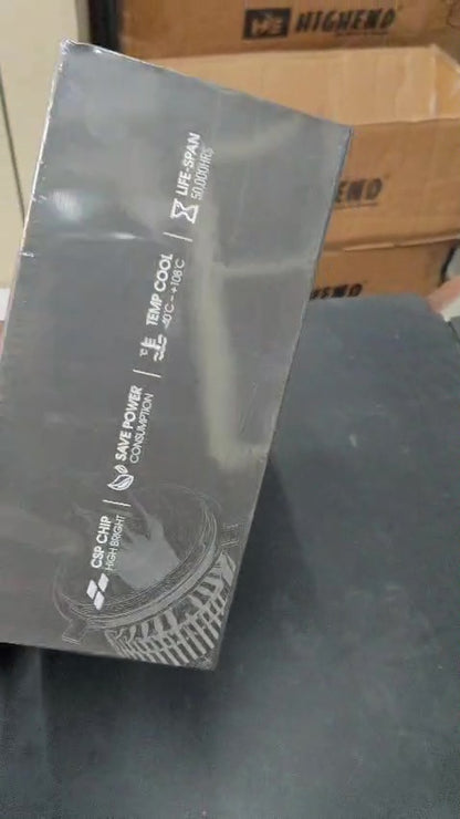 Electronic component packaging on a gray surface with cardboard boxes in the background