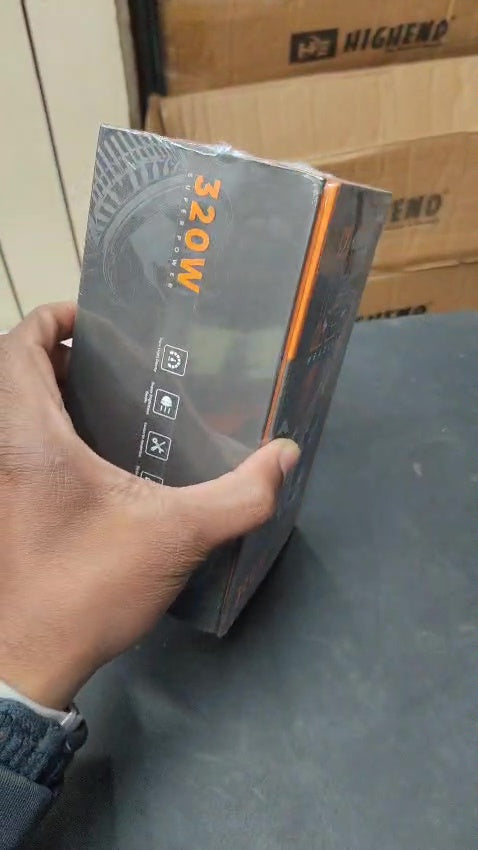 Person holding a power adapter with '200W' label against a cardboard box background