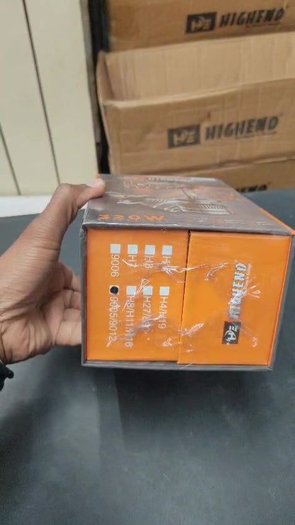 Hand holding a box of 'Mengshen' products with cardboard boxes in the background.