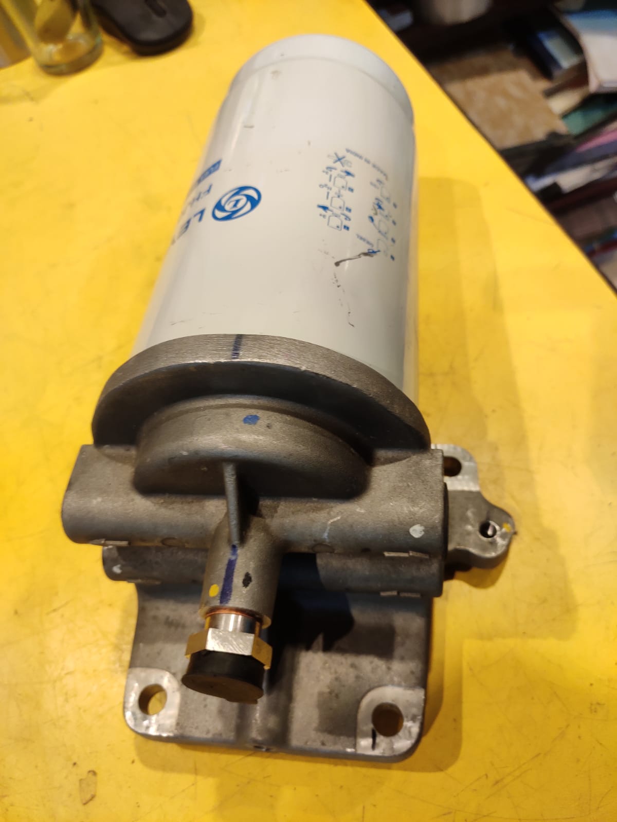 Mechanical component on a yellow surface