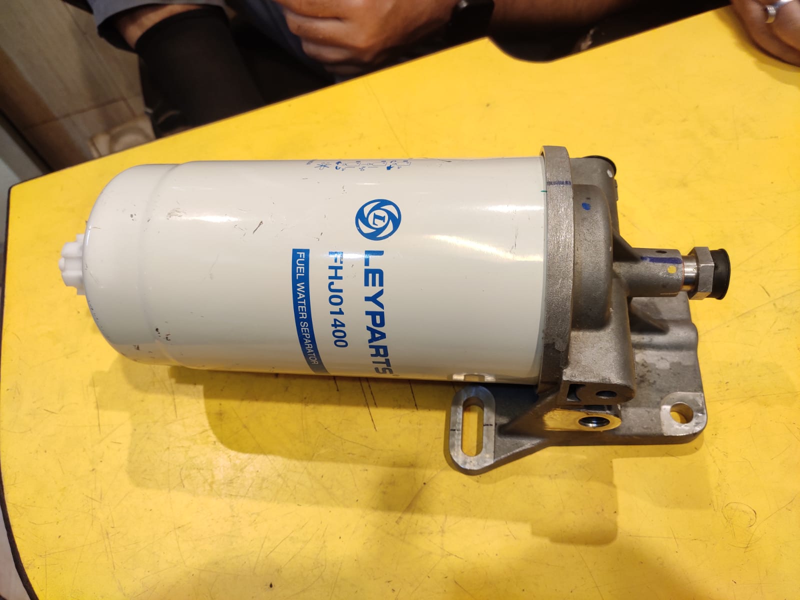 Fuel filter with LEYPARTS branding on a yellow surface