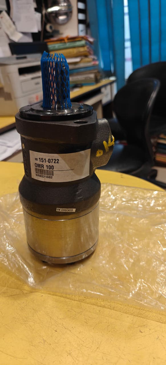 Mechanical component on a yellow surface with a blurred background