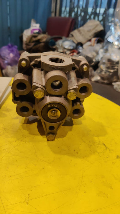 Mechanical component on a yellow surface with a cluttered background