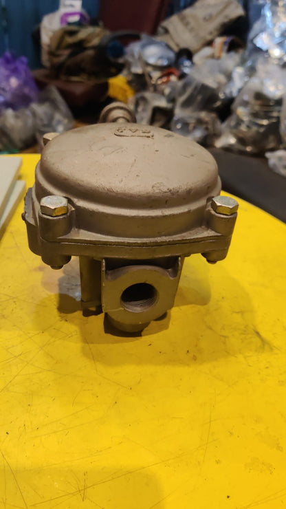 Metal mechanical component on a yellow surface with blurred background