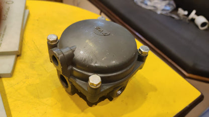 Mechanical component on a yellow surface with blurred background