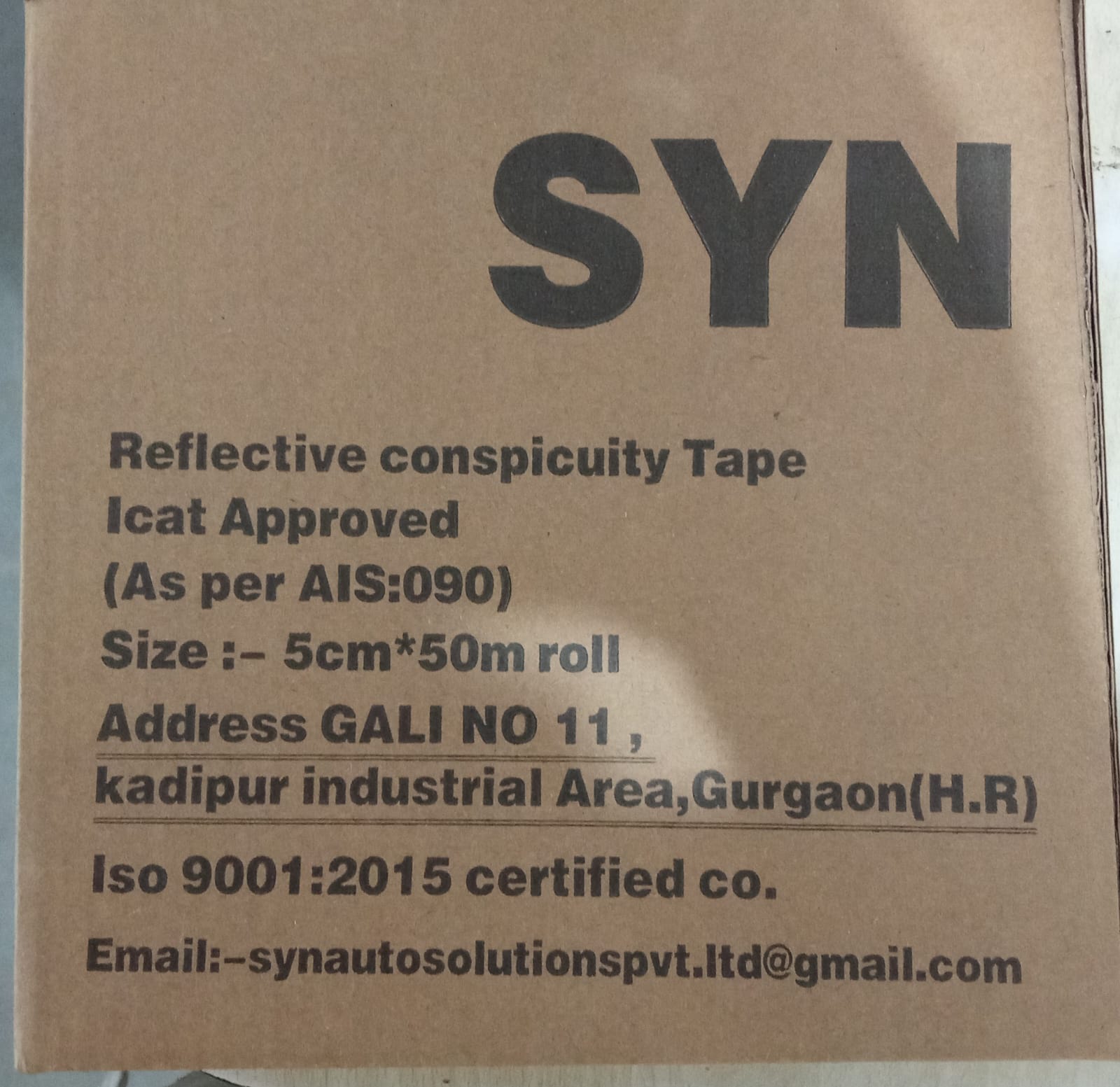 Cardboard box with reflective conspicuity tape details on a brown background