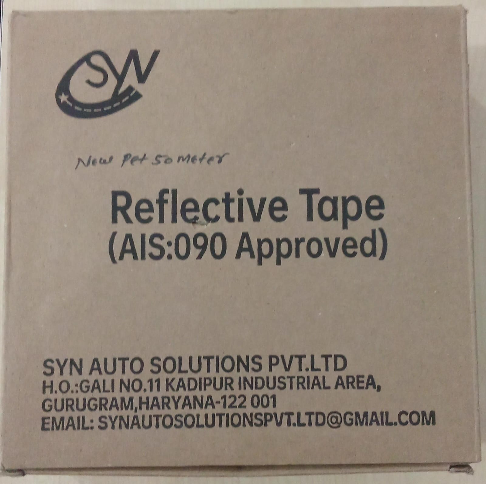 Cardboard box with reflective tape product details and SYN Auto Solutions Pvt. Ltd branding.