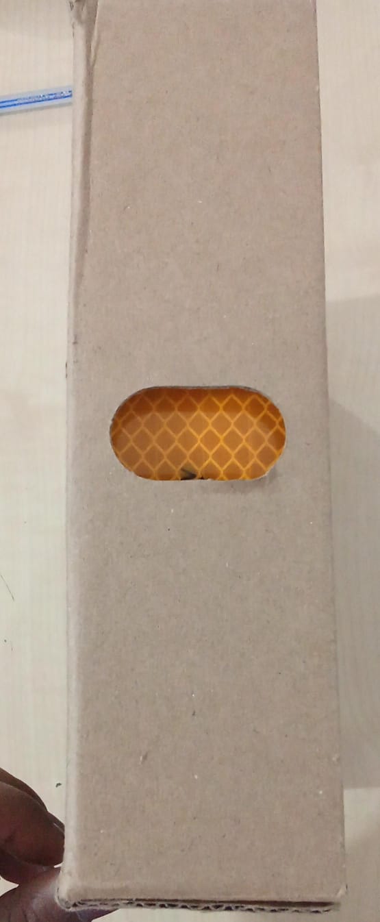 Small rectangular object with a textured surface on a plain background