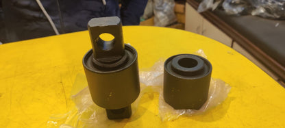 Two mechanical components on a yellow surface with a blurred background