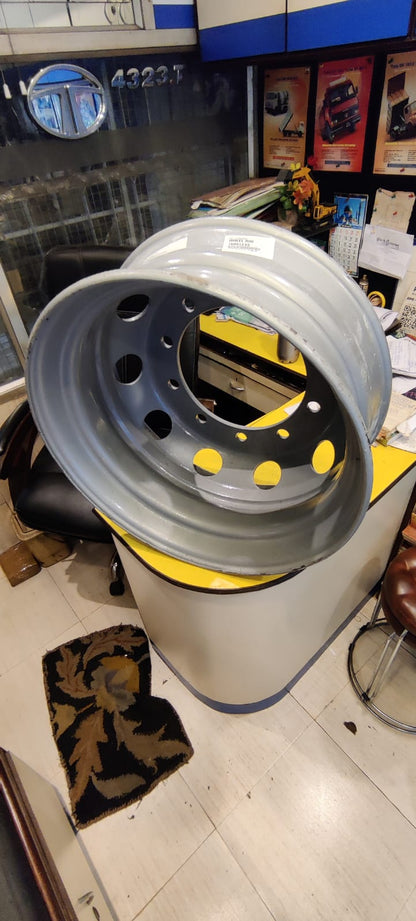 Close-up of a wheel rim on a stand in a workshop setting