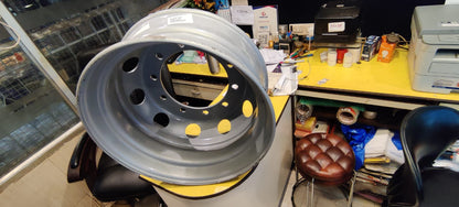 Metal rim on a stand in a workshop setting