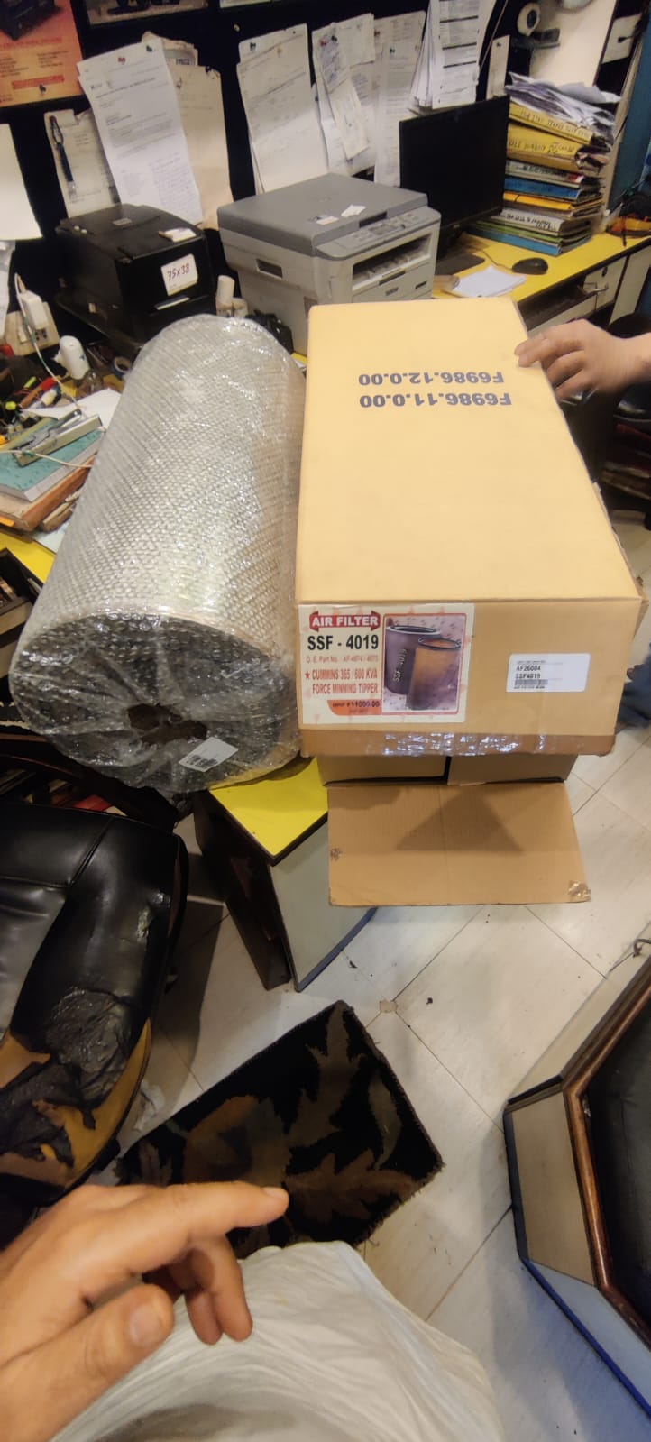 Box with bubble wrap and a person's hand in a store setting