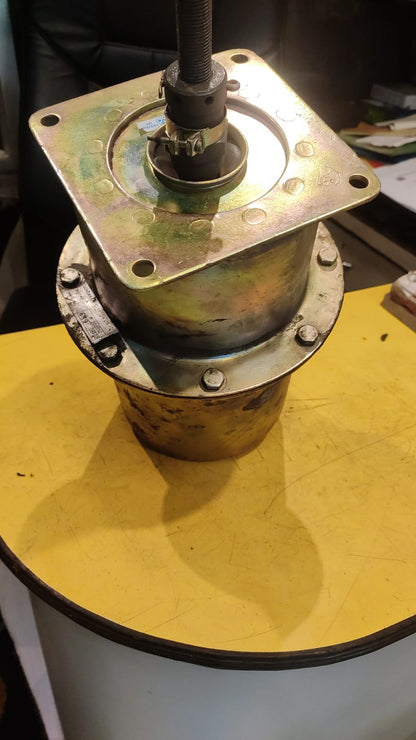 Metal mechanical component on a yellow surface