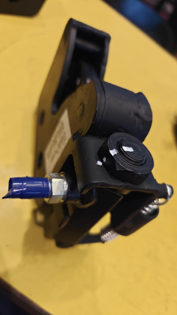 Mechanical component with a blue connector on a yellow background