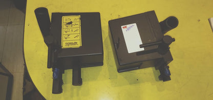 Two electronic devices on a yellow surface with visible branding and labels.