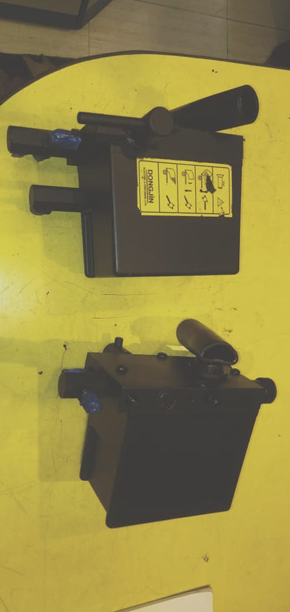 Black mechanical component on a yellow background
