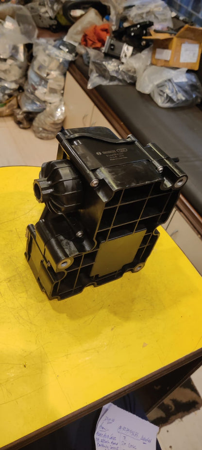 Mechanical component on a yellow surface with a cluttered background