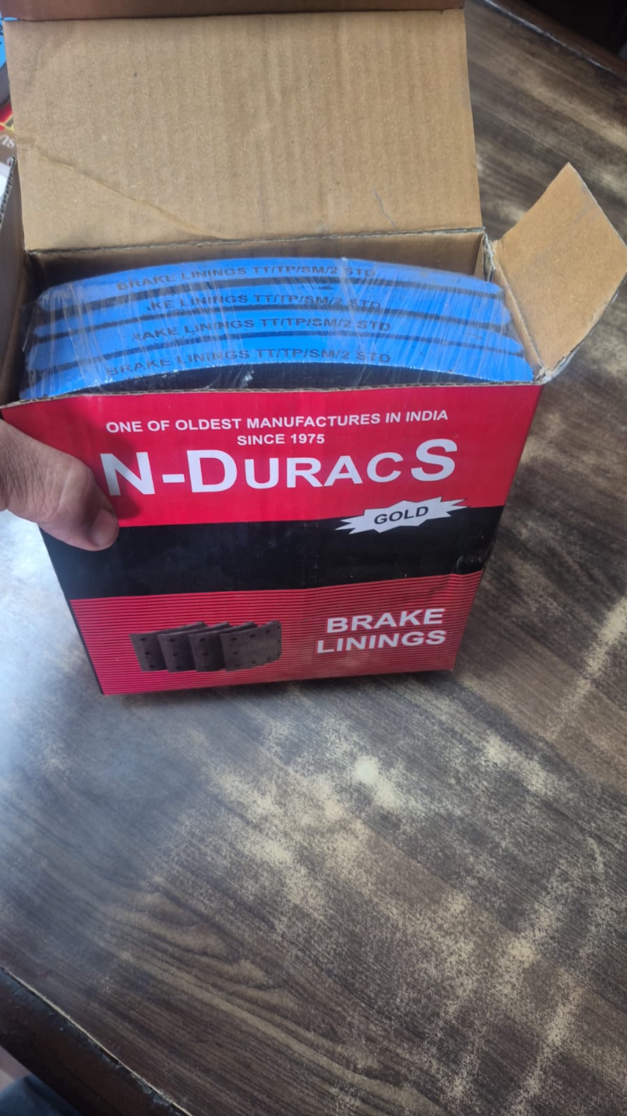 Box of N-Duracs brake linings on a wooden surface