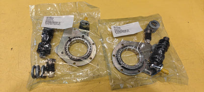 Two packages of mechanical parts on a yellow surface