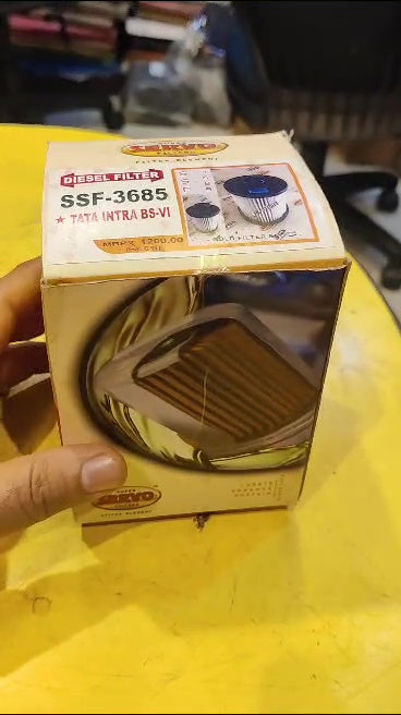 Box of a product with visible branding and model number on a yellow surface.